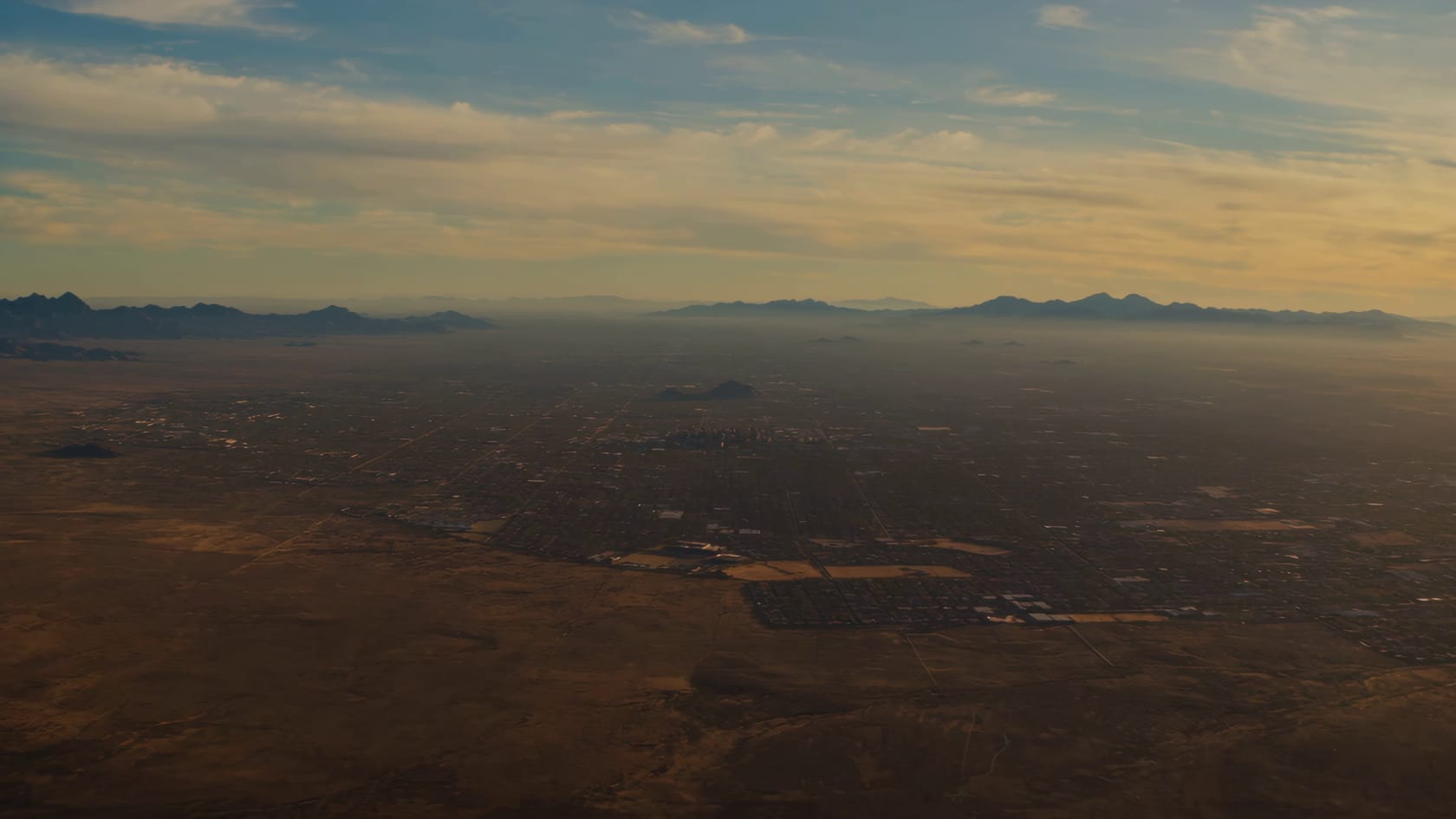 A golden-hour flight from high above Phoenix, down through rush-hour traffic and packed rooftops, over Camelback Mountain and out to a family’s manufactured home on its own Arizona acreage